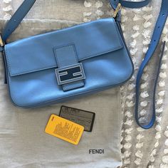 Baby Light Blue Fendi Baguette With Convertible Straps With Authenticity Card. Still Has Compact Mirror Wrapped In Plastic. Light Corner Wear On 2 Corners As Seen In Pics. Comes With Dust Bag, 2 Straps, Compact Mirror, Authenticity Card. Excellent Shape. Luxury Blue Baguette Bag, Luxury Blue Rectangular Baguette Bag, Designer Baguette Bag With Branded Hardware, Designer Everyday Baguette Bag, Designer Light Blue Shoulder Bag For Evening, Luxury Blue Baguette Bag For Everyday Use, Elegant Blue Baguette Bag With Removable Pouch, Elegant Blue Baguette Bag For Evening, Elegant Blue Baguette Bag For Shopping