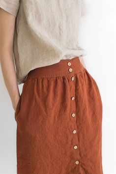 "DETAILS * High waisted linen skirt * Two side pockets and natural coconut buttons at the front * Feel comfortable with elastic band at the back * The knee length will make you feel elegant * Made from soft wash medium weight (185 gsm) 100 % European linen fabric * Height of the model is 165 cm (5′ 5″) and she is wearing skirt in size XS/S * Color - burnt orange. Please choose another color and size on the right * Product number: SK03 CARE LABEL * machine wash gentle (40 C/104 F) * dry gentle on low heat * wrinkles give the character so there is no need to iron, but if you still prefer it - iron at low heat SIZING XS/S EU 34-36 / UK 6-8 / USA 4-6 BODY / Recommended body measurements for the size XS/S: - bust in 86-92 cm / 34\"-36\" - waist in 64-70 cm / 25\"-28\" - hips in 92-98 cm / 36\"- Cheap Orange Relaxed Fit Skirt, Summer Skirt With Buttoned Pockets, Beach Linen Skirt With Elastic Waistband, Cotton Beach Skirt With Buttons, Relaxed Brown Skirt With Buttons, Beach Cotton Skirt With Buttons, Beach Linen Skirt With Pockets, Brown Button Closure Skirt For Summer, Brown Skirt With Button Closure For Summer