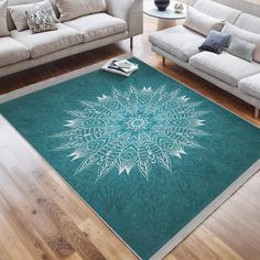 a living room with couches and a large rug on the floor in front of it