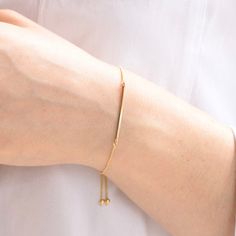 "Gold bar bracelet, Adjustable Bar Bracelet, Delicate bracelet Minimal, delicate 14k gold bar bracelet. The bar is 14k solid gold, it is about 1.25\". It is about 2mm width. 14k gold adjustable bracelet (it is 8\") To see more bracelets, click on the link below. https://www.etsy.com/shop/SashJewelry?section_id=12354075 To see more Sash Jewelry items click on the link below. http://www.etsy.com/shop/SashJewelry Please don't hesitate to contact me for custom orders. Thank you for stopping by." Elegant Yellow Gold Bracelets With Sliding Knot, Minimalist 14k Gold Name Bracelet With Adjustable Chain, Elegant Yellow Gold Bracelet With Sliding Knot, Adjustable Simple Yellow Gold Bracelet, Gold Minimalist Chain Bracelet With Adjustable Length, Adjustable Yellow Gold Bracelets With Simple Design, Minimalist Gold Chain Bracelet With Adjustable Length, Adjustable Yellow Gold Bracelet With Simple Design, Minimalist Yellow Gold Bracelet With Sliding Knot