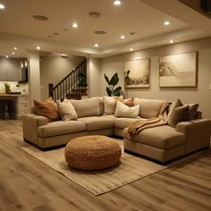 a living room filled with lots of furniture next to a stair case in a house