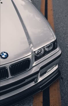 the front end of a silver bmw car