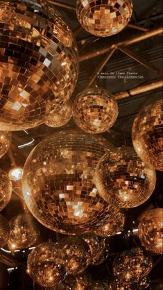 many shiny disco balls hanging from the ceiling