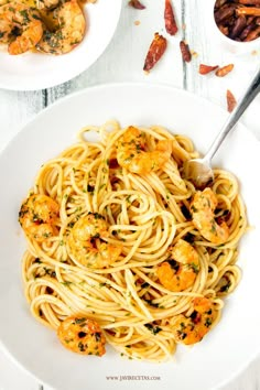 pasta with shrimp and parmesan cheese in a white bowl