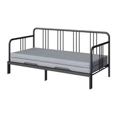 a black metal daybed with mattress underneath it