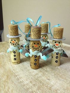 four snowmen made out of wine corks on a table