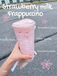 a hand holding up a pink drink with information about it's ingredients on the side