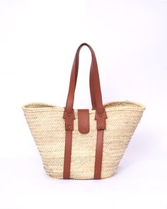 Do you want to look stylish and hippy? Get your hands on this handmade straw bag. It's high quality, eco-friendly, and handcrafted by women in Morocco. Its design is unique and timeless. Get yours now! we are proud to introduce our signature straw french bag to you. it is handmade by our talented artisan who has been working with us for years. this beautiful bag has a unique design that you would find nowhere else. the light and durable material are ideal for taking the bag on your adventures. S Brown Straw Crochet Bucket Bag, Brown Crochet Straw Bucket Bag, Beige Basket Straw Bag With Adjustable Strap, Bohemian Natural Beach Bag For Everyday Use, Brown Straw Bucket Bag With Braided Handles, Eco-friendly Natural Straw Bag, Bohemian Style Natural Beach Bag, Natural Palm Leaf Beach Bag For Travel, Natural Straw Bag With Bamboo Handle For Everyday Use