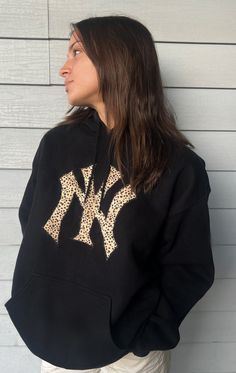 Super comfy black hoodie with NY Yankee Logo! (Can also do other teams & colors DM and ask!) Black Tops With Ribbed Cuffs For Game Day, Black Sweatshirt For Game Day Sports Season, Black Letter Print Hoodie For Fall, Black Sweatshirt For Game Day, Team Spirit Graphic Hoodie For Winter, Winter Team Spirit Hoodie With Graphic Print, Winter Team Spirit Graphic Hoodie, Black Team Spirit Sweatshirt For Fall, Black Varsity Hoodie