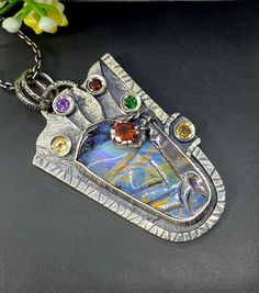 "Carved Australian Opal gemstone pendant necklace in sterling silver Hand-made Sterling Silver 925. Stones used: Australian Opal, Citrine, Amethyst, Garnet, Chrome Diopside Height - 2 1/4\" (with bail), Width - 1 1/4\" Chain length 20 inches Unique Handcrafted One-of a-kind Design Pendant Each Piece of Jewelry in my Collection is Absolutely One of a Kind! When you start wearing a piece of my jewelry you will fall in love with it more and more each day and feel that good Energy and Love that I pa Silver Fusion Necklace With Cabochon, Unique Sterling Silver Necklace With Rectangular Pendant, Custom One-of-a-kind Pendant Necklace As Gift, Custom One Of A Kind Pendant Necklace, Custom One-of-a-kind Pendant Necklace Gift, Silver Cabochon Pendant Gemstone, Silver Cabochon Gemstone Pendant, Multi-stone Oval Pendant Necklace For Gift, Unique Collectible Necklace With Rectangular Pendant