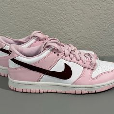 The Nike Dunk Low Pink Red White Gs Features A White Leather Upper Complemented By Pink Overlays And A Deep Red, Purple-Like Shade Marking The Swoosh. The Pink Continues To The Mudguard, Lacing System, And Heel, While Underneath, The Nike Dunk Keeps Its Classic Color Blocking With A White Midsole And A Pink Outsole And Treading. Sporty Pink Skate Shoes With Boost Midsole, Pink Low-top Skate Shoes With Boost Midsole, Sporty Pink Sneakers With Rubber Sole, Trendy Pink Skate Shoes With Laces, Trendy Pink Lace Skate Shoes, Pink High-top Skate Shoes With Boost Midsole, Pink Sneakers For Streetwear With Laces, Pink Low-top Sneakers With Boost Midsole, Pink High-top Custom Sneakers For Sports