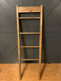 an old wooden ladder leaning against a wall