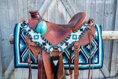 a saddle with a blue and white blanket on it