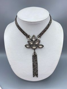 Vintage 1980's Erickson Beamon rhinestone 3 Chain necklace with large pendant and rhinestone tassels. 16" choker with a 2 1/2" wide pendant and 3 1/2" long tassels. Features marquise rhinestones surrounded by small rounds. Very good condition with original Japanning, which is a blackening technique and it looks like it effected some of the rhinestones in the small links. I have a collection of Beamon pieces from a Clients mother's estate. She shopped Paris and NYC in the 1980's and was quite wealthy and fashionable. I have not been able to find any of her collection of pieces online so I believe they are all one of a kind. Erickson Beamon is an iconic jewelry brand that stands out for its remarkable fusion of creativity and craftsmanship. Listing is cross posted!  Founded by Karen Erickson Antique Jeweled Necklaces For Evening, Glamorous Necklaces With Rhinestones, Glamorous Dangle Necklaces With Rhinestones, Costume Jewelry Rhinestone Pendant Necklace, Costume Jewelry Rhinestone Choker Necklace, Metal Rhinestone Costume Jewelry Necklace, Costume Jewelry Crystal Choker For Parties, Glamorous Jeweled Choker Necklace, Elegant Large Pendant Choker Necklace