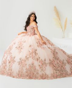 All eyes will be on you in this 3D floral applique long off shoulder dress with A-line glitter tulle skirt by House of Wu 26027. Make a statement modern lace and tulle ball gown. An exquisite off should V-neck ball gown is made extra special with sparkling floral sequins and embroidered appliques along the bodice. The full ball gown skirt is accented with large lace appliques. Features a lace-up back. Note: Extended train is not included. Train Style #26027T. House of Wu Quinceanera Collection F Floral Quinceanera Dress, Long Off Shoulder Dress, Rose Gold Quince Dresses, Train House, Rose Gold Quince, Quinceanera Collection, Royal Train, Gold Quince, Quinceañera Dresses