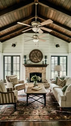 a living room filled with furniture and a clock on the wall above the fire place