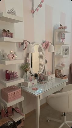 a white desk topped with a mirror and lots of shelves next to a wall mounted shelf