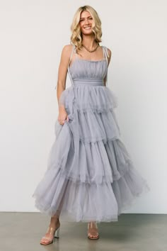 Baltic Born exclusive style Add a touch of whimsical magic to your next event! Gorgeous dusty slate that pulls periwinkle hues Tulle material Classic straight neckline Romantic tank straps with tie details Elastic at back of waist with stretch Romantic layered ruffle maxi skirt Lined bodice and skirt 100% Polyester Bridesmaid Dresses Velvet, Ethereal Dress, Dresses Velvet, Ruffle Maxi Skirt, Tulle Material, Destination Dress, Dresses Holiday, Dresses Wrap, Tulle Bridesmaid Dress