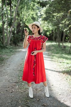 "Vintage Mexican Oaxaca dress with florals embroidered. Short sleeves with colorful floral hand embroidery throughout. Red cotton material. Tailored chest with crochet lace trim and little people on smocking. Condition: In very good vintage condition just a small stain and white spot on hips area Measurements (Inch) size estimate: M *Measurements are taken in inches with the garment laying flat. BUST: 42 \" HIPS: 70 \" FULL LENGTH: 44 \" SLEEVE LENGTH: 4.5 \" shoulder to shoulder : 15 \" Our mod Red Bohemian Embroidered Dress With Floral Details, Red Folk Embroidered Dress With Floral Design, Red Bohemian Dress With Geometric Embroidery, Red Folk Style Embroidered Dress, Red Bohemian Dress With Floral Embroidery, Bohemian Red Dress With Geometric Embroidery, Red Folk Style Dress With Floral Embroidery, Red Folk Style Dress With Intricate Embroidery, Red Folk Style Dress With Embroidered Hem