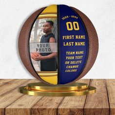 a basketball trophy with a photo on the front and back side, sitting on top of a wooden table