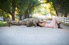 a woman laying on the ground next to a soldier