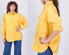 "Vintage 80s yellow cotton button up shirt with two chest pockets. It has long sleeves that roll up and secure with a button. Fits unisex. Measurements and Condition: Fits like: Labeled one size fits all, can fit up to men's large and women's XL Fabric: Cotton Brand: Chennachi Condition: Very good, with some very faint red color bleed on the lower back, a couple tiny white paint spots and a couple other minor small spots scattered throughout, and the right sleeve button has been replaced. Length Yellow Workwear Tops With Pockets, Oversized Yellow Tops With Pockets, Oversized Yellow Top With Pockets, Spring Yellow Shirt With Pockets, Oversized Yellow Tops With Button Closure, Yellow Work Shirt With Pockets, Yellow Workwear Shirt With Pockets, Yellow Shirt With Pockets In Relaxed Fit, Yellow Relaxed Fit Shirt With Pockets