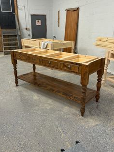 a wooden table with drawers on it in a room