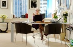 a woman sitting at a table in an office