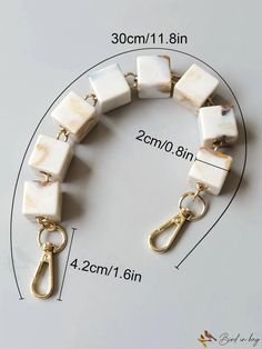 a bracelet with white and gold squares on it, measurements for each beaded item