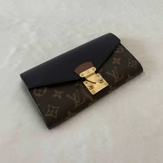 Description: Louis Vuitton Monogram Noir Pallas Wallet Includes Dustbag and Box Condition: Pre/Loved in Good Condition. Minor Scratches at Hardware and Leather Wrinkling Estimated Retail: $1,140 Details: Monogram Coated Canvas / Black LeatherGold-Tone Hardware4 Compartments, One with Zipper10 Card SlotsPush Button Closure Measurement: Width 19cm / Height 11cm / Depth 2cm For more details on this item, contact us on bagsarenaon@gmail.com or Louis Vuitton Wallet Women, Lv Pouch, Purse Must Haves, Designer Wallets For Women, Cute Mini Backpacks, My Style Bags, Pre Owned Louis Vuitton, Hot Bags, Mini Backpacks