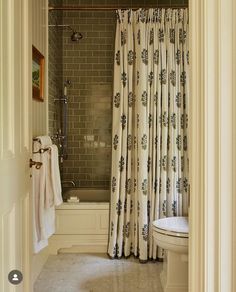 an open door leading to a bathroom with a toilet, shower and bathtub in it