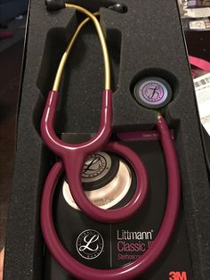 a red stethoscope sitting in a black box