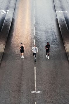 three people are running down the street in front of an advertisement for nike's new campaign