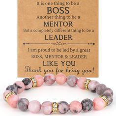 a bracelet with pink and grey beads on it, next to a card that says boss