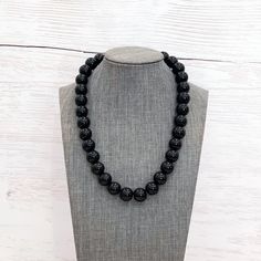 This classic unisex black necklace was hand beaded using 14mm round black glass beads - perfect for everyday wear! The necklace measures your choice of 18, 22, 26, or 30 inches in length and is securely fastened with a silver clasp. The end result is a versatile piece that goes with everything! Check out more fabulous jewelry and enter my shop here: https://www.etsy.com/shop/jewelbytessyla View the positive feedback I've received from customers and check out some beautiful art prints for nursery Adjustable Black Beaded Necklaces With 8mm Beads, Black Single Strand Necklace, Black Onyx Round Bead Necklace, Adjustable Black Beaded Necklaces With Round Beads, Classic Black Beaded Necklaces With Polished Beads, Adjustable Black Beaded Necklace With Gemstone Beads, Adjustable Black Gemstone Beaded Necklace, Classic Black Beaded Necklace With Polished Beads, Classic Black Necklaces With 8mm Beads