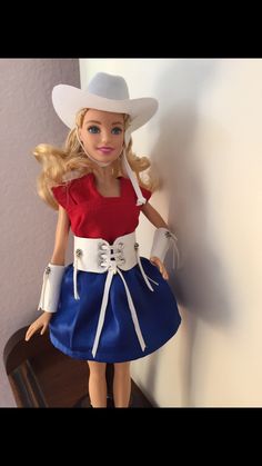 a barbie doll wearing a red white and blue dress with a cowboy hat on her head