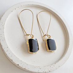 Where the timeless elegance meets modern vibes, that's where you'll find these drop earrings. GEMSTONE: Black Onyx CLOSURE: Gold plated kidney ear wires LENGTH: 2" long Black Elegant Earrings, Elegant Metal Threader Earrings For Everyday, Modern Black Jewelry With Ear Wire, Elegant Metal Threader Earrings With Ear Wire, Metal Long Drop Linear Earrings With Ear Wire, Trendy Metal Linear Earrings With Ear Wire, Black Enamel Drop Earrings, Elegant Black Everyday Earrings, Black Brass Hoop Earrings As Gift