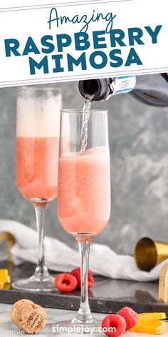 two champagne flutes filled with raspberry mimosa