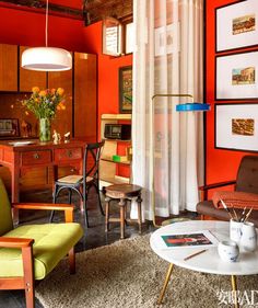 a living room filled with furniture and orange walls