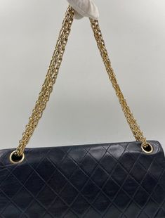 This vintage Classic Chanel Flap bag is crafted from diamond quilted black lambskin leather with 24k gold-plated hardware and a convertible reissue chain shoulder strap. There is a single exterior patch pocket on the back, a single zip pocket under the front flap and three interior compartments. Inside the bag is lined with maroon leather. The longest chain drop for this bag is 35cm and the chain doubled and at its shortest is 20cm. This bag is in good vintage condition with some signs of use. There are some minor wrinkles to some parts of the leather and some colour fade to the gold plated hardware. The hallmark on the CC turn lock confirms the gold hardware is plated in 24K gold, a real collectors item. Before 2008, Chanel Classic Flaps with gold coloured hardware (chains, clasps, gromme Timeless Quilted Double Flap Bag, Classic Double Flap Bag With Chain Strap, Quilted Double Flap Shoulder Bag For Travel, Classic Quilted Shoulder Bag For Everyday Luxury, Luxury Quilted Double Flap Bag, Classic Flap Bag With Chain Strap, Classic Rectangular Shoulder Bag With Diamond Quilting, Vintage Black Quilted Shoulder Bag, Classic Quilted Flap Bag For Everyday Use