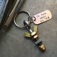 a keychain that says, i'm not about you on it next to a wrench