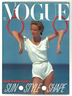 a magazine cover with a woman in white on the front and an image of a man holding two red rings