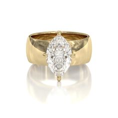 a yellow gold ring with a pear shaped diamond