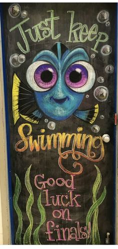 an image of a door decorated with chalk and watercolors that says, just keep swimming good luck on friday