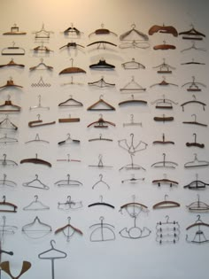 there are many clothes hangers on the wall