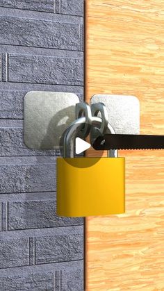 a yellow padlock attached to a wooden door with a key hanging from the lock