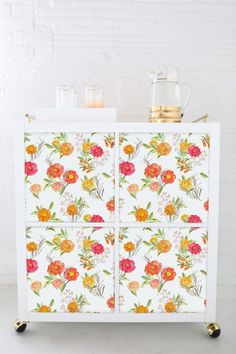 a white cabinet with flowers painted on it