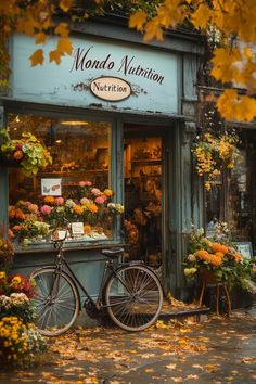 a bicycle is parked in front of a flower shop