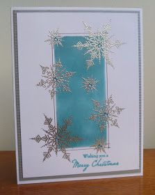 a card that has snowflakes on it and the words merry christmas written in blue