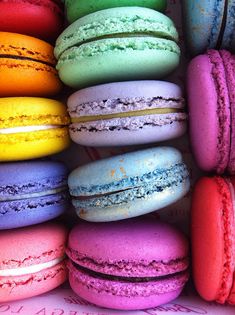 there are many different colored macaroons in the box